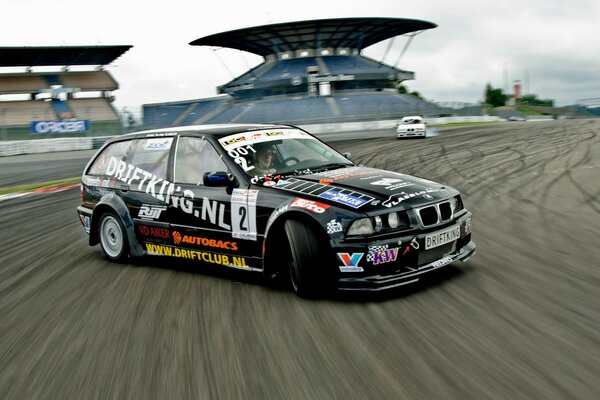 A black tuned car drifts on the track