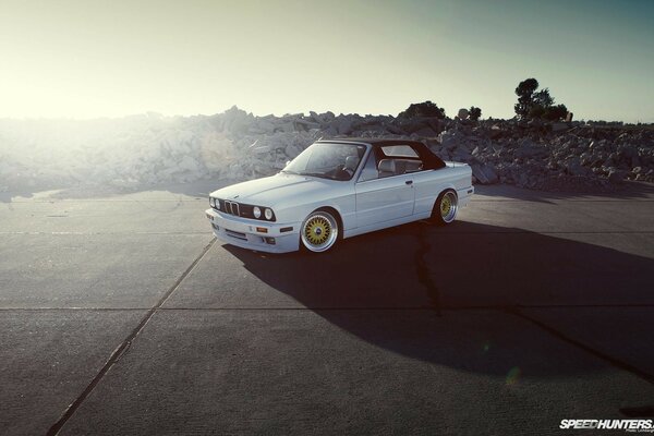 Bmw e30 on the background of nature on the road