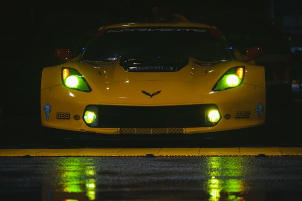 Yellow Chevrolet Corvette with green headlights