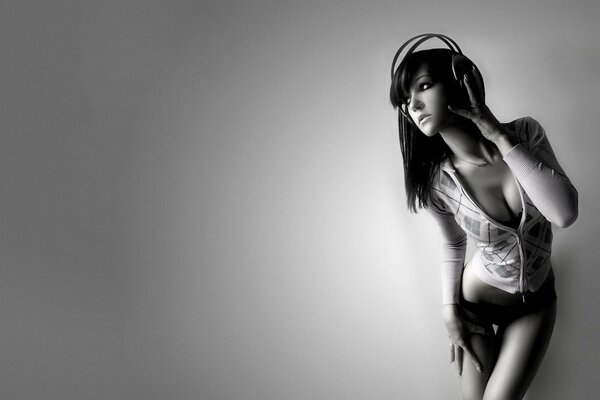 Young sexy girl in headphones. Black and white image