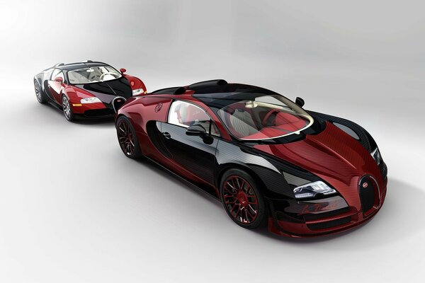 Dwa Czarno-Czerwone samochody sportowe Bugatti Veyron