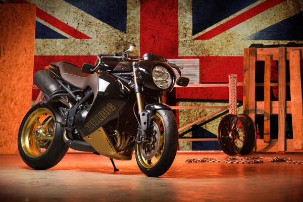 Czarny motocykl Triumph speed triple na tle flagi Wielkiej Brytanii