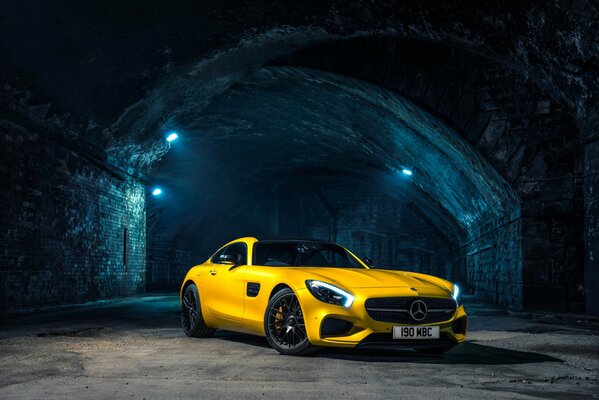 Yellow mercedes in a tunnel with illuminated lights