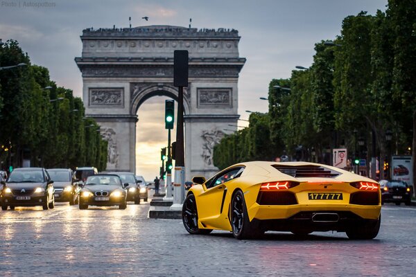 Yellow Lamborghini car on a busy road background