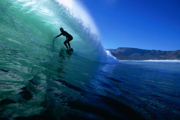 Surfer snowboarding on a wave in the ocean