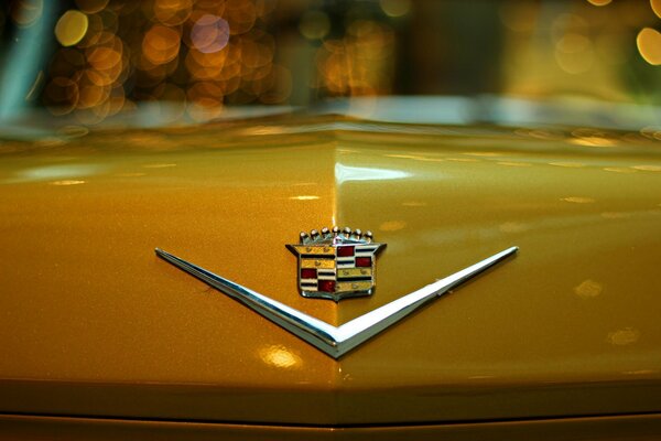 Cadillac emblem on a yellow car