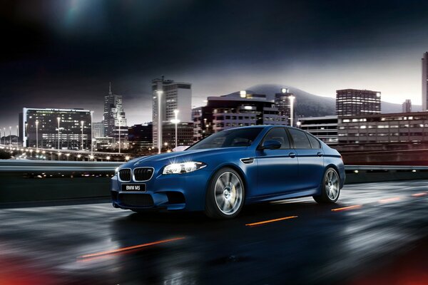 Blue BMW in the lights of the night city