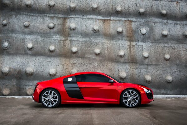 Red Audi side view against a gray wall
