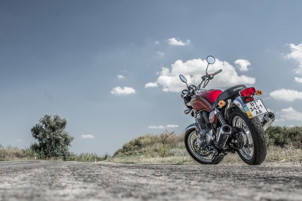 A red motorcycle is standing on the road