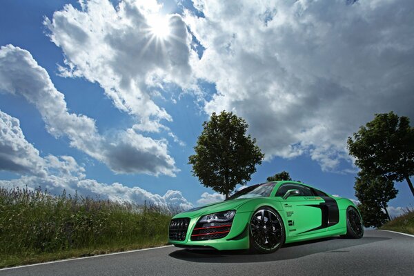 Green Audi car on the sky background