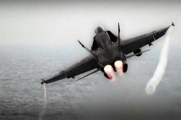 A military fighter over the ocean in action