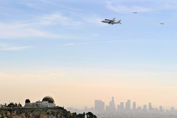 Three planes in the sky over the city