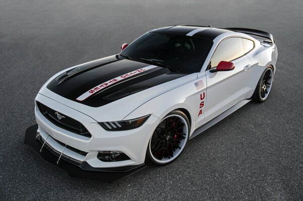 A white Ford car stands on the asphalt