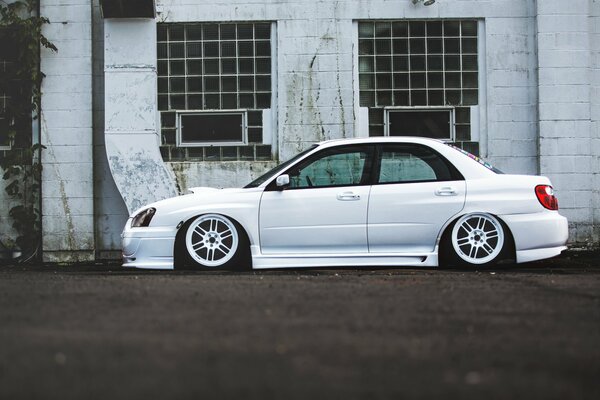 Understated white subaru impreza on the side