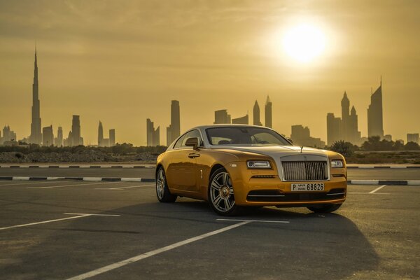 A gold-colored car on the background of Dubai