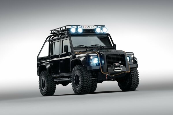Land Rover Defknder car with headlights on