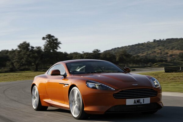 Aston Martin on the road under a clear sky