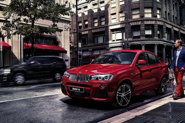 Red BMW with a man in the metropolis