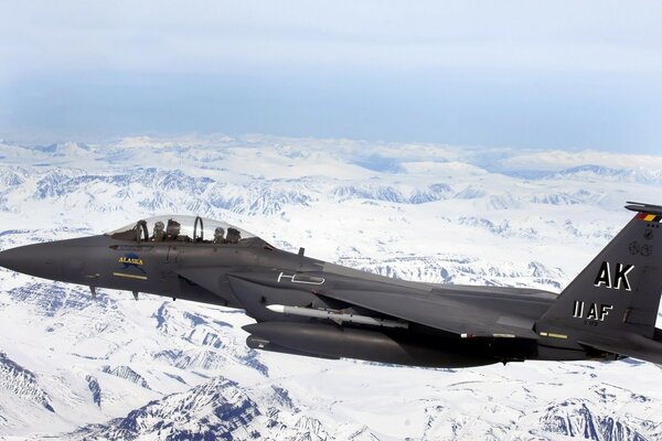 F - 15e on the background of white snow in the mountains of Alaska