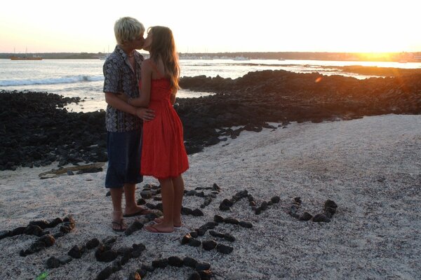 A kiss of a couple in love at sunset