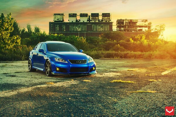 Blue Lexus on the background of the setting sun