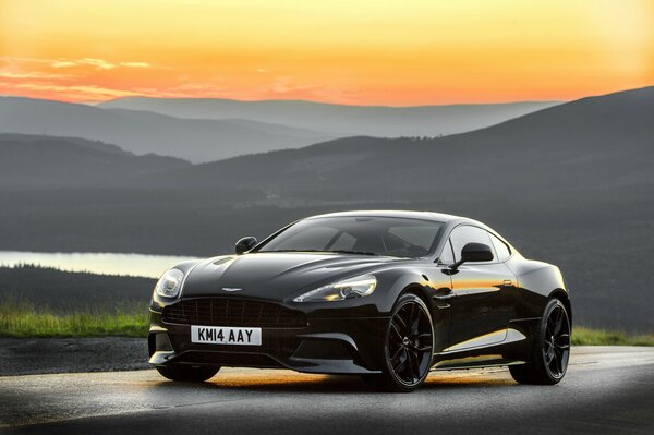 Black Aston Martin on the background of a beautiful landscape