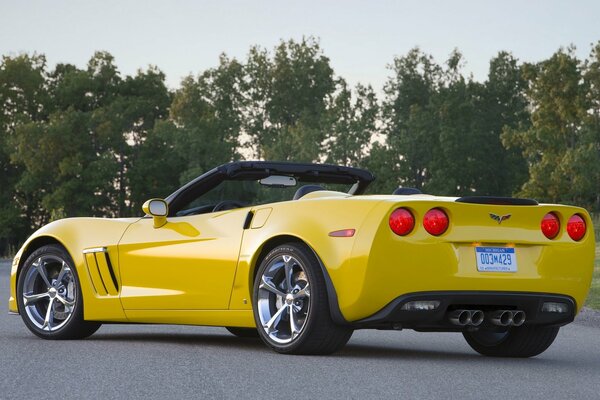 Corvette amarillo en la carretera con Llantas cromadas