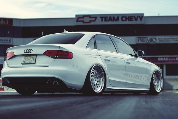 White Audi A4 on the road with tinted