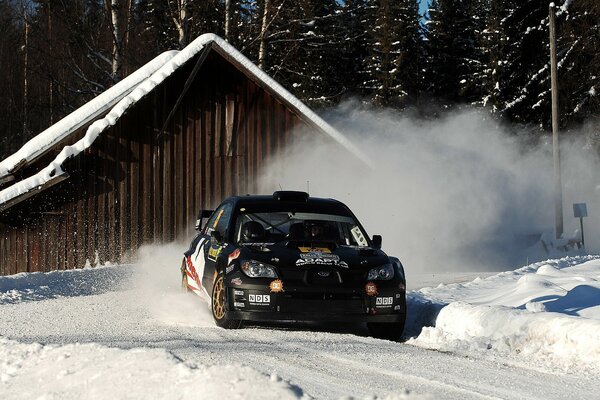 Subaru is driving on a snowy road at high speed