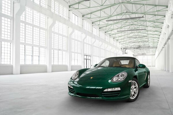 A green Porsche in a snow-white parking lot