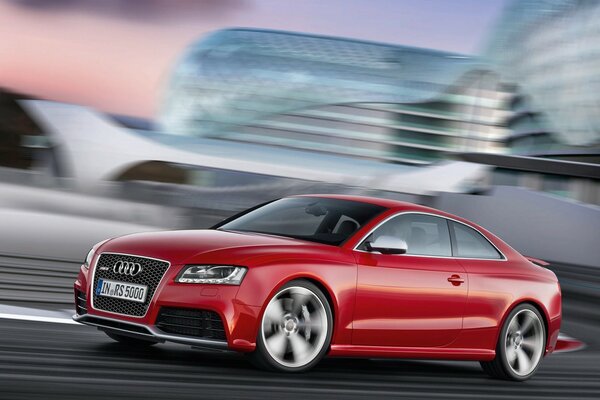 Audi red at breakneck speed rushes along the highway