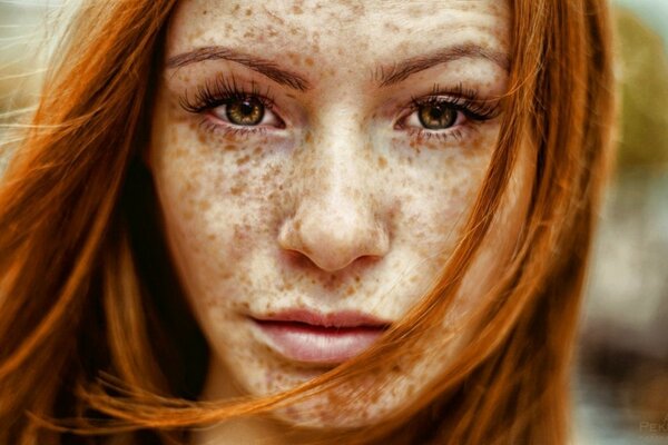 Red-haired girl with a beautiful face