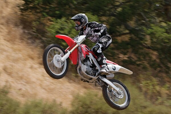 A rider in a helmet. Jump on a motorcycle