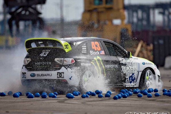 Subaru impreza drove on blue balloons with water