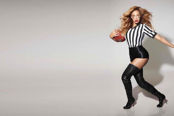 Beyonce z piłką na szarym tle