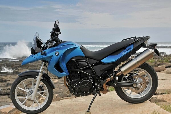 Blue bike on the background of a rocky beach