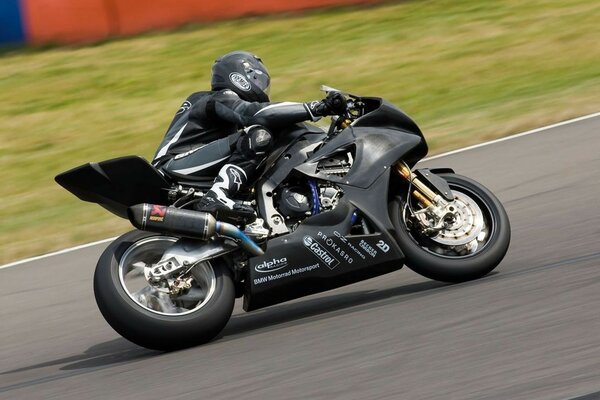 A motorcyclist on a bike rides fast on the road