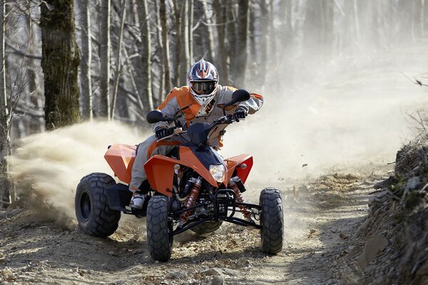 The ATV drifts, leaving a cloud of dust behind it