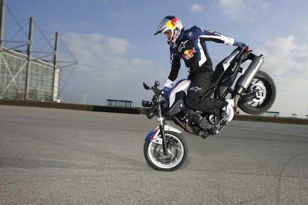 Motorcycle stunt on a concrete platform