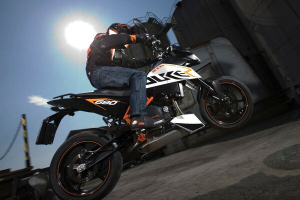 KTM motorcycle in motion against a clear sky