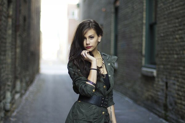 Photo of a supermodel near a brick house