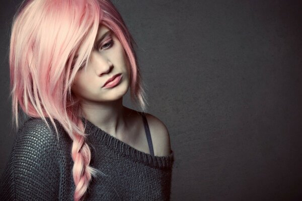 A girl with pink hair on a gray background