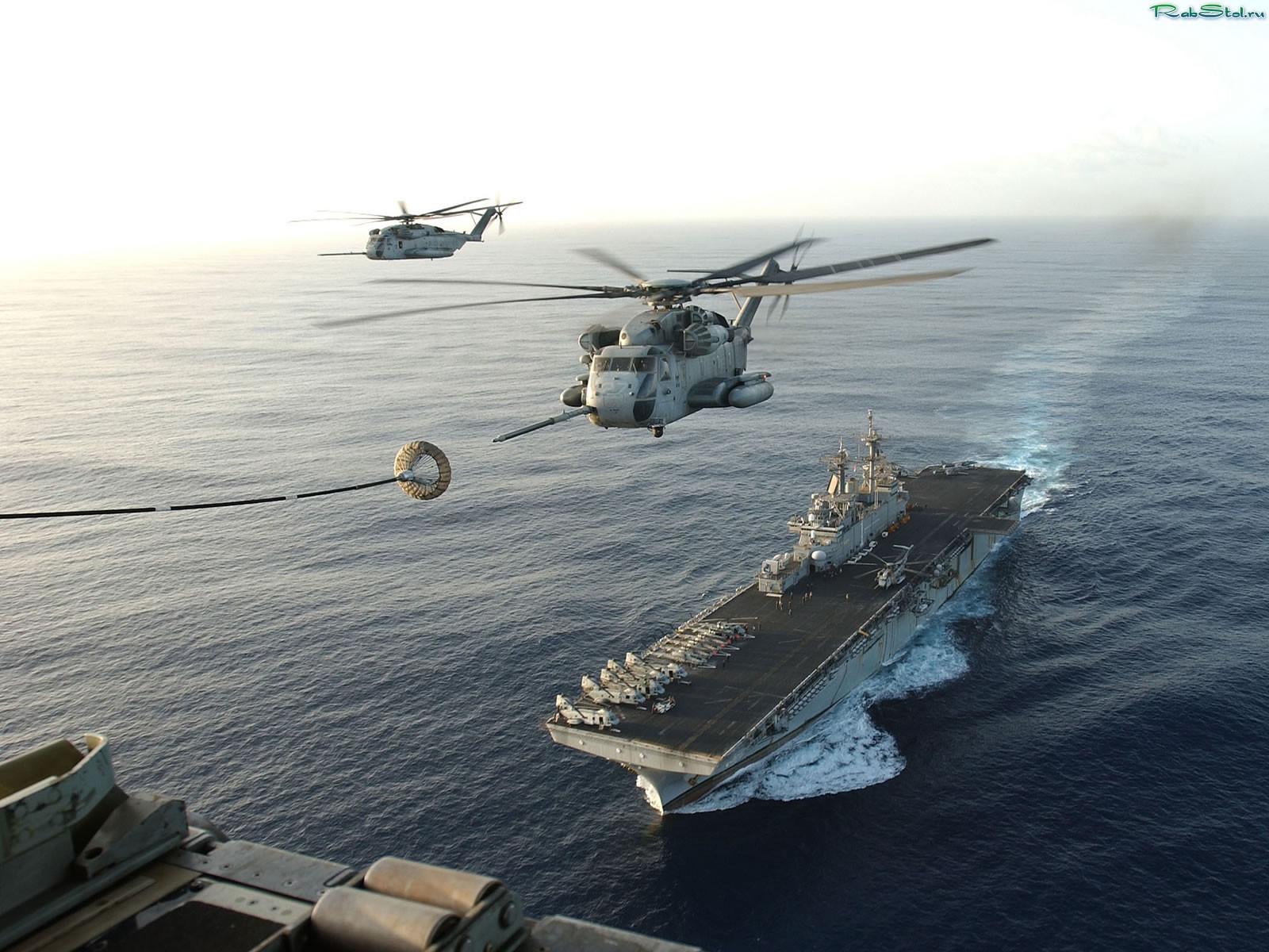 helicopters refueling the carrier