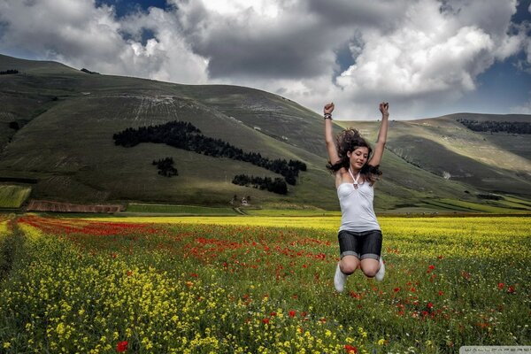 Girl jumping on the background of mountains