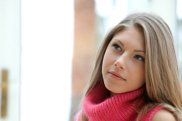 Sguardo di bella ragazza bionda in rosa