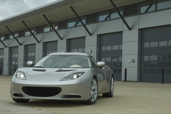 Gray Lotus car on the background of the building