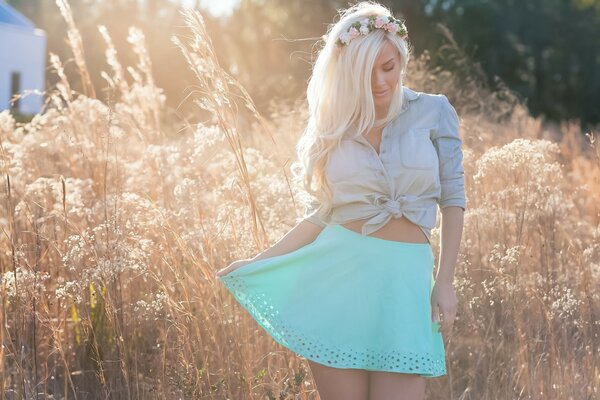 Blonde model in a blue skirt