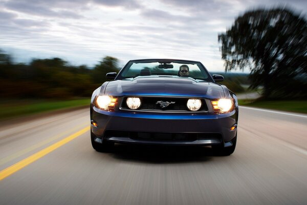 The Mustang car is going at full speed