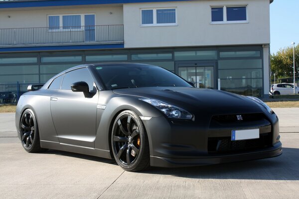 Black matte Nissan on the street in daylight