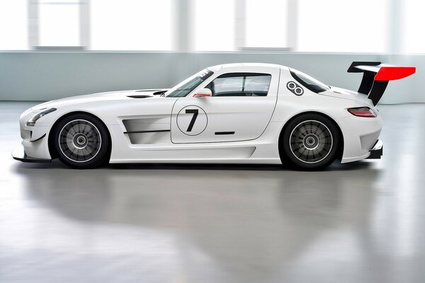 White racing Mercedes in a bright room